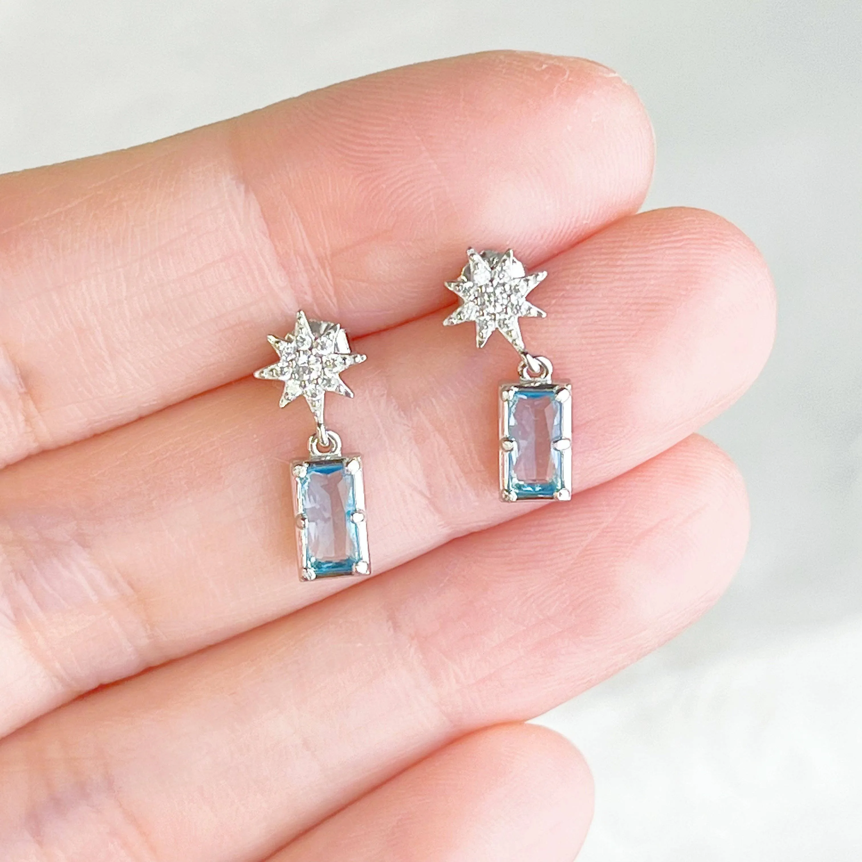 Ninaouity Silver Pole Star and Blue Square Crystal Earrings